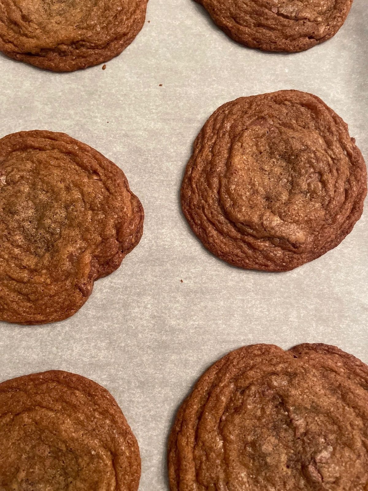 Brown butter chocolate chip cookies on parchment