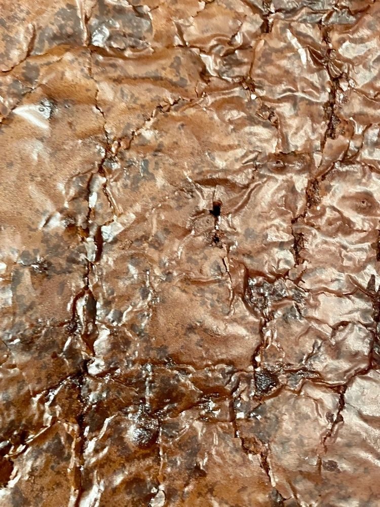 Close-up of the crackly top of a tray of brownies