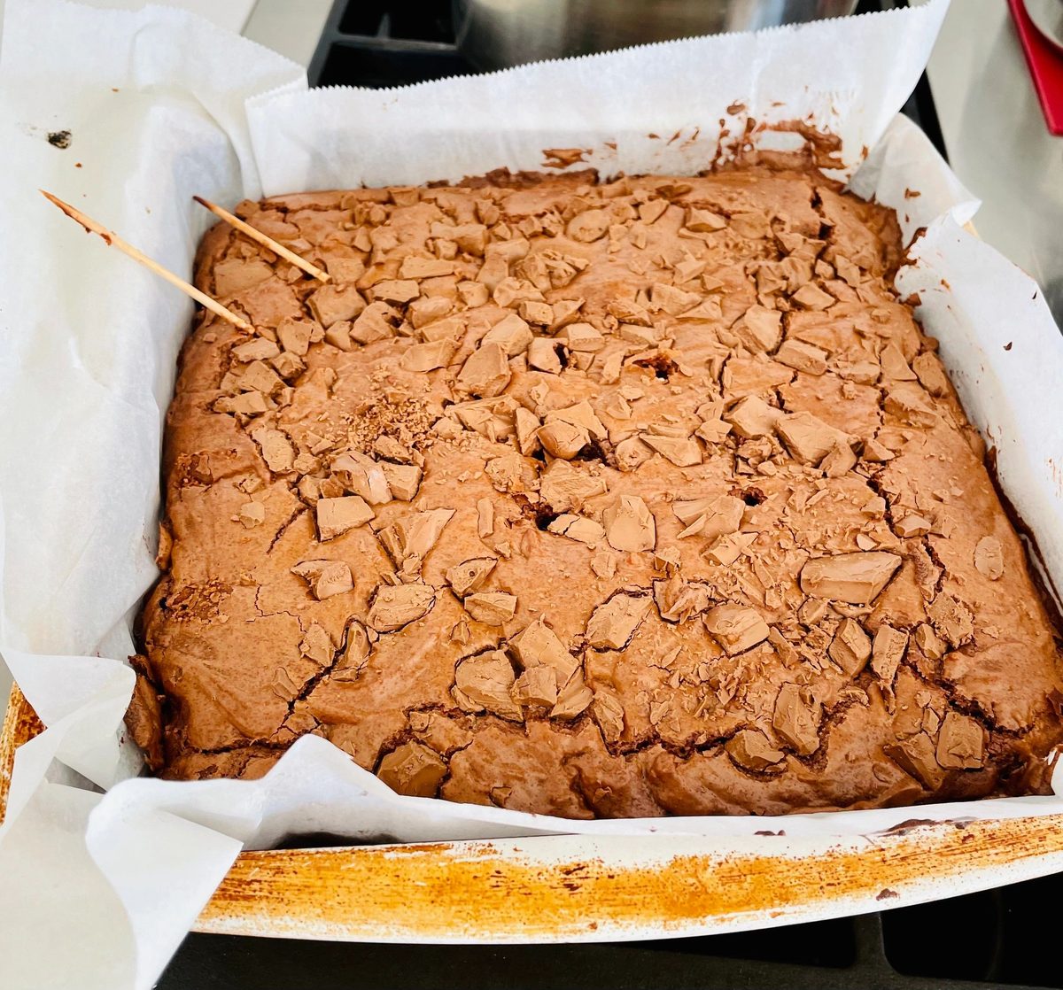 Brownies baked in a parchment-lined pan
