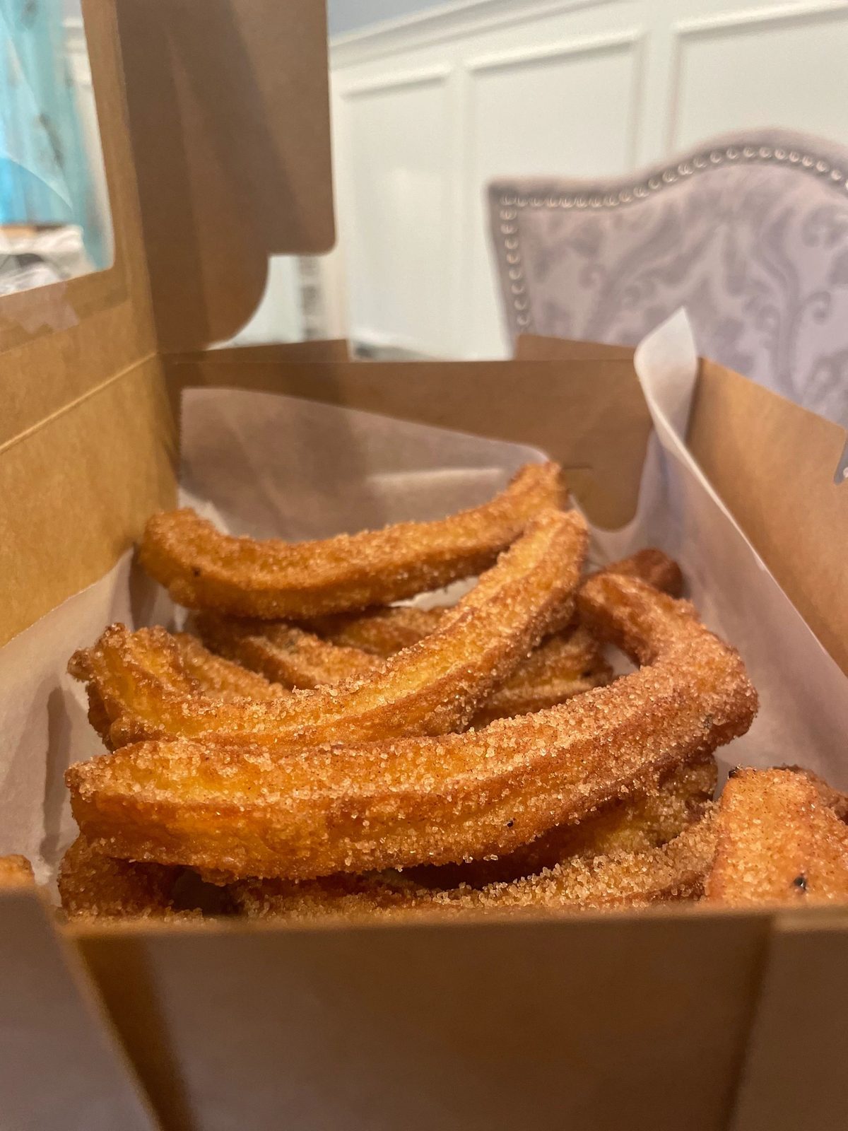 Cinnamon sugar churros in a bakery box