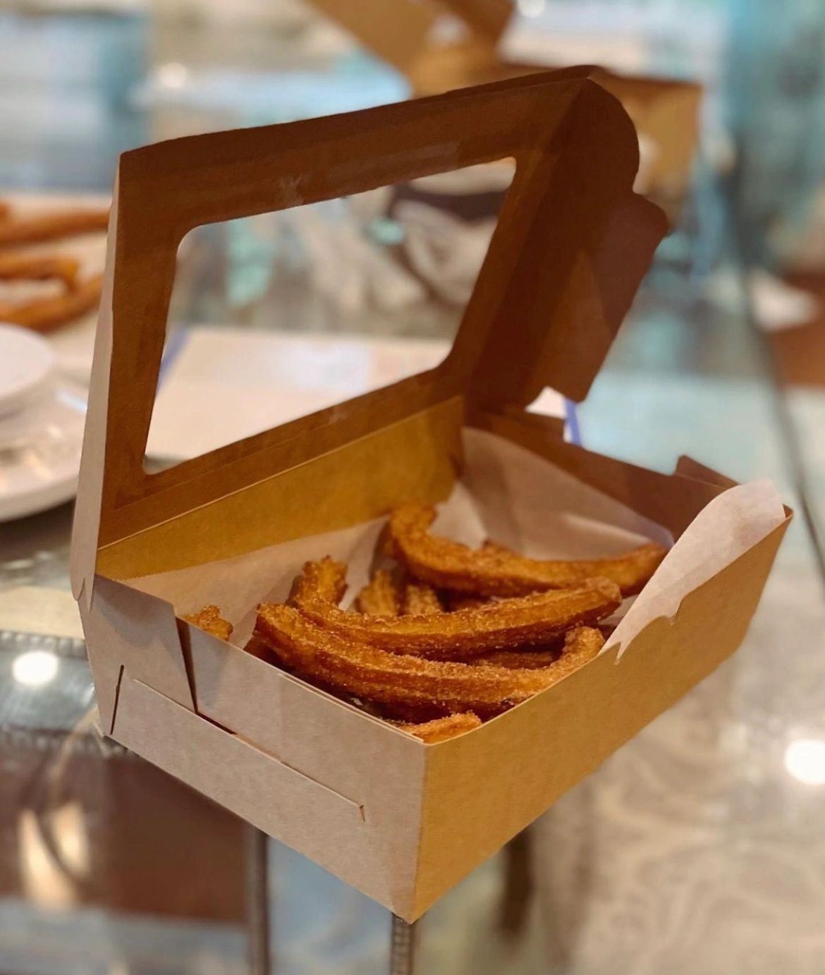 Churros in an open bakery box