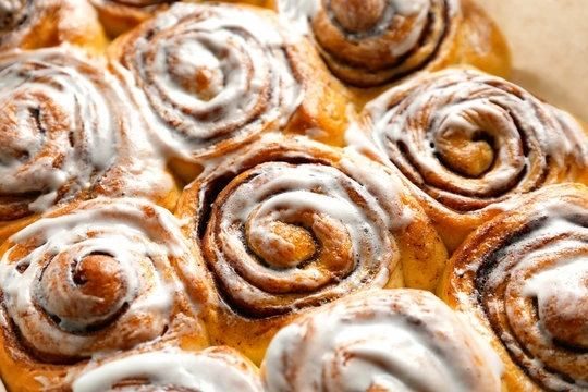 Iced cinnamon rolls in a pan