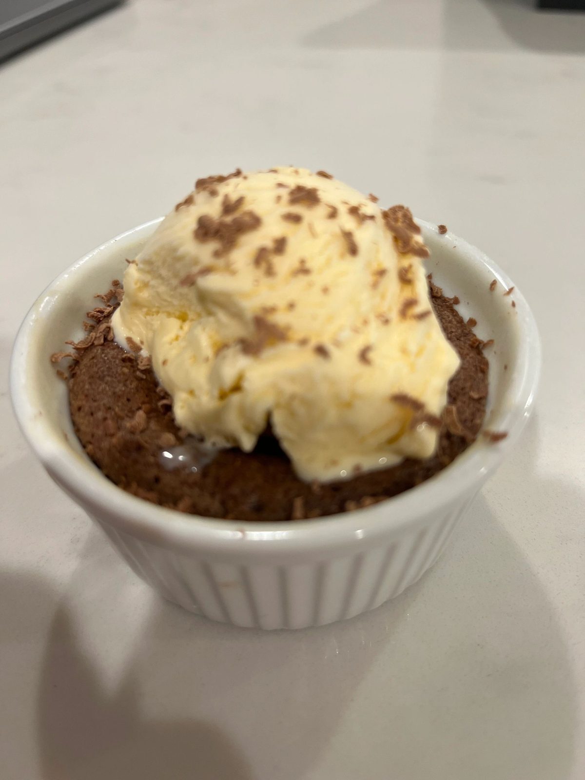 Chocolate molten lava cake topped with a scoop of ice cream