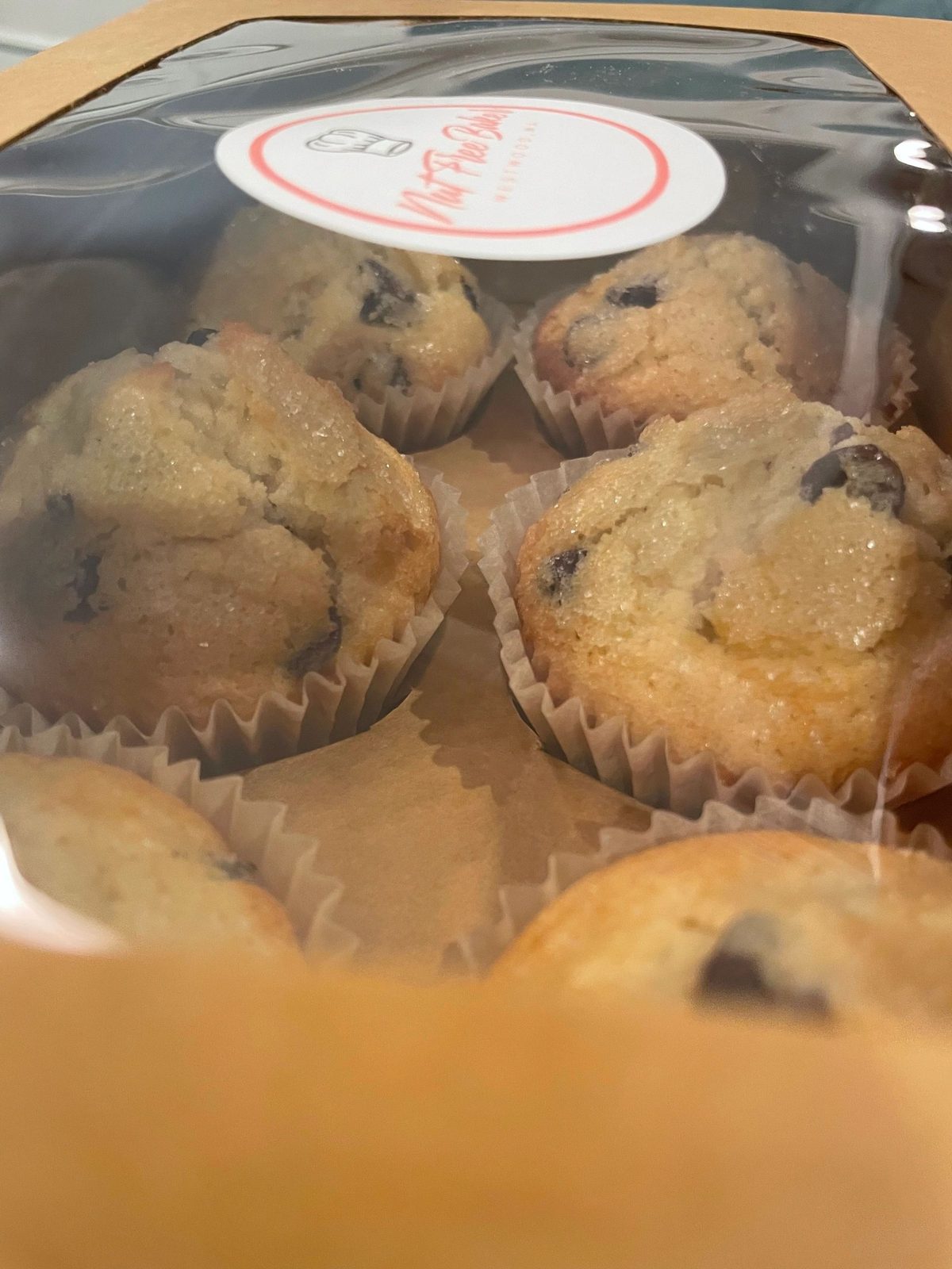 Chocolate chip muffins boxed with a Nut Free Baker sticker